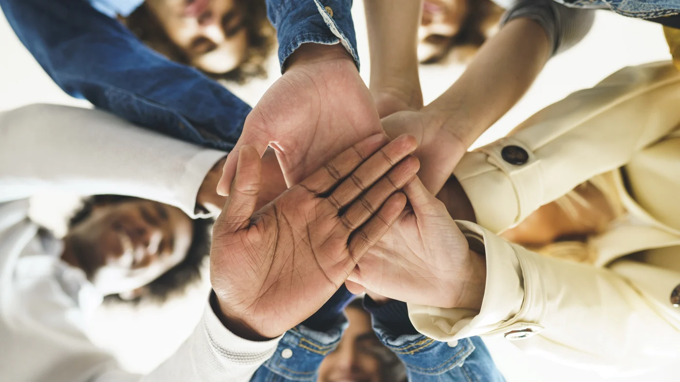 Ogden Community Outreach – HVAC – Absolute Comfort Close-up of multiple hands together in Ogden, UT community