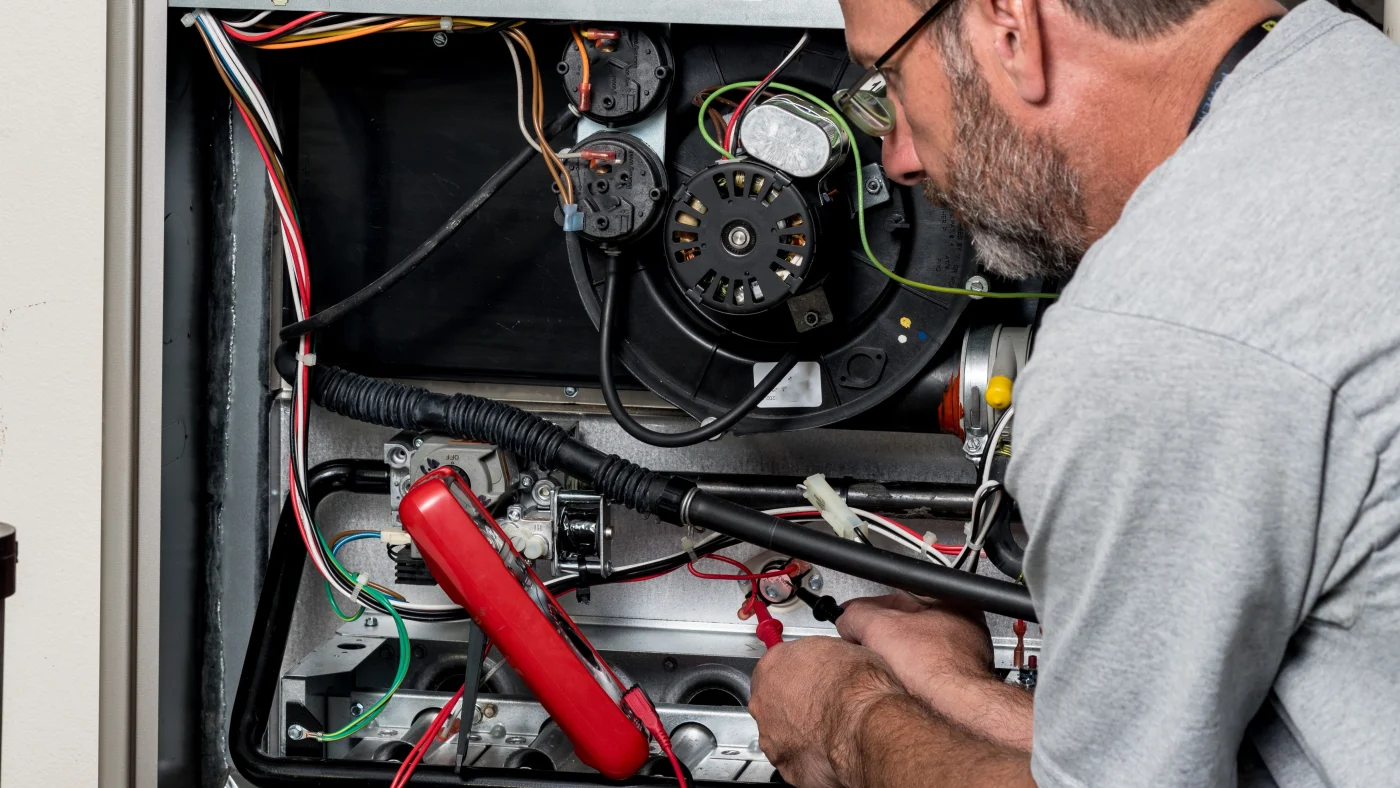 Heating Repair – Ogden, Utah – Absolute Comfort Furnace in an Ogden, Utah home being repaired by a technician from Absolute Heating & Air Conditioning