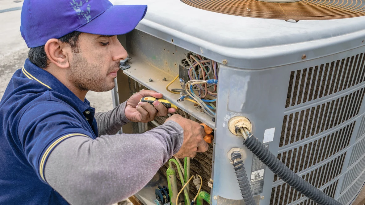 HVAC Installation – Ogden, Utah – Absolute Comfort HVAC technician works on installing new air conditioner