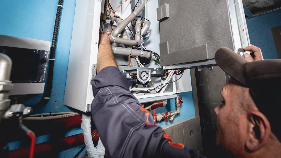 HVAC professionals – Ogden, UT – Absolute Comfort Absolute Comfort HVAC technician works on Ogden AC repair