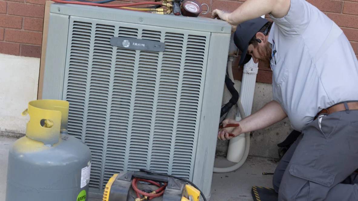 AC Repair - Ogden, UT - Absolute Comfort Absolute Comfort employee repairs Ogden AC unit