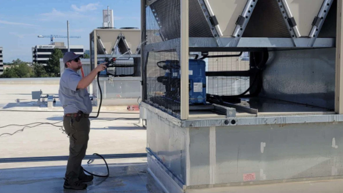 AC Maintenance – Absolute Comfort – Ogden, Utah Absolute Comfort technician cleans AC condenser during maintenance