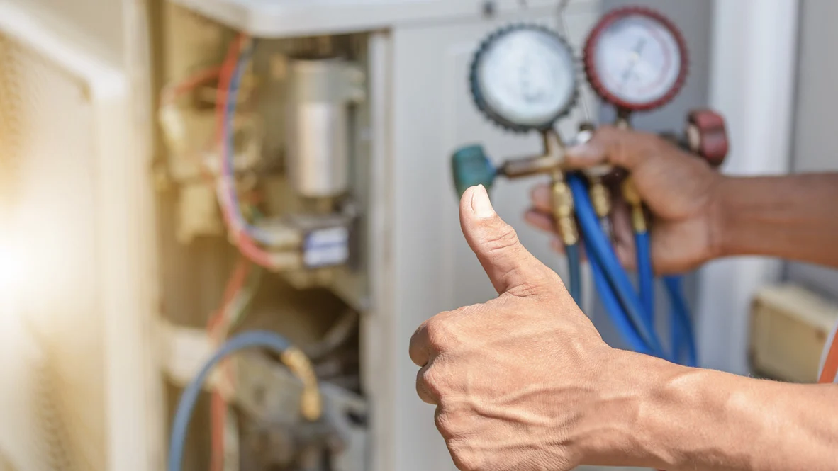 Heating & Cooling Technician – Ogden, Utah – Absolute Comfort HVAC technician gives thumbs up to camera while holding testing meter