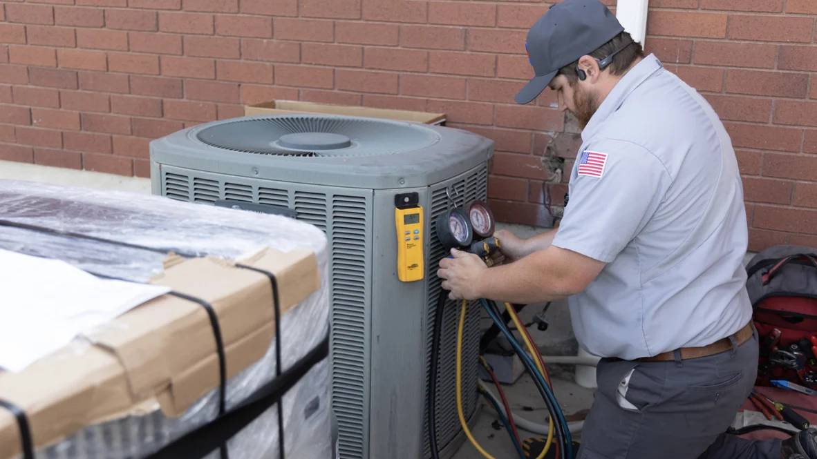 Air Conditioning AC Installation Hvac Service Ogden Absolute Comfort Absolute Comfort technician installs new Ogden AC system
