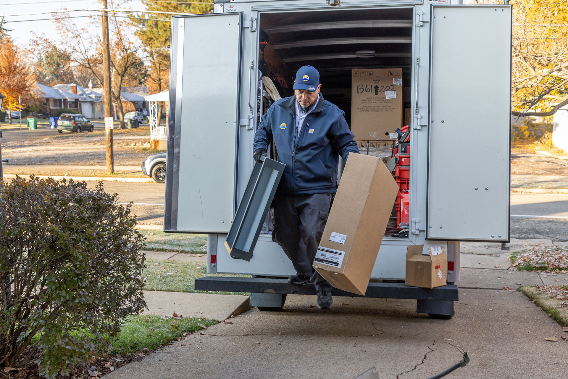 HVAC Satisfaction – Ogden, Utah – Absolute Comfort Absolute Comfort smiles next to Amana furnace after Ogden install
